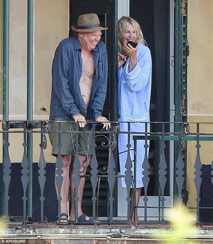 Daryl Hannah plants a loving kiss on boyfriend Neil Young in Portofino