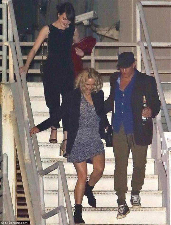 Jennifer Lawrence helped down stairs by Woody Harrelson at Adele show